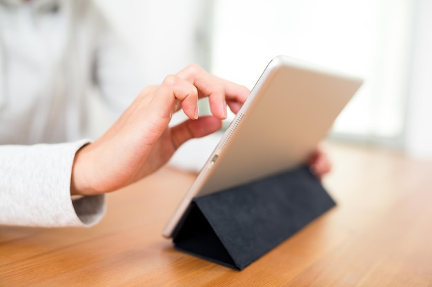 Woman using tablet computer at home