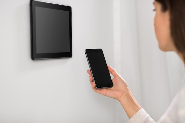 woman using tablet computer and smartphone