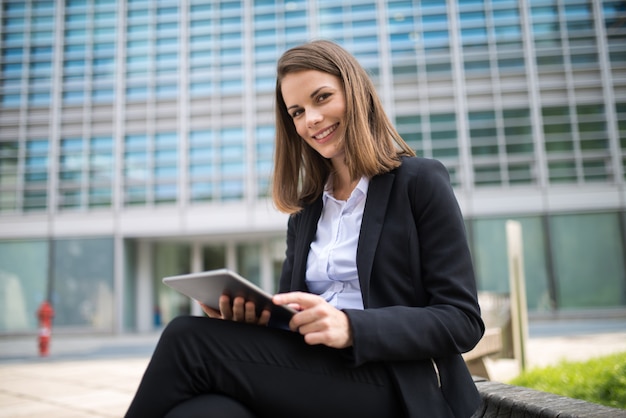 Woman using a tablet in front of her office