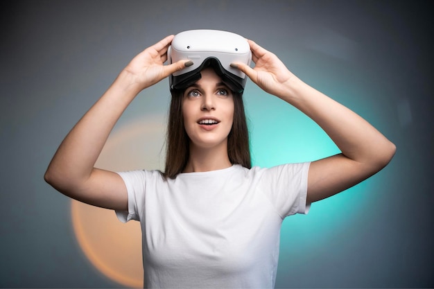 Woman using a virtual reality headset isolated on colorful background