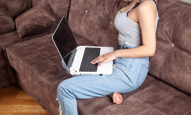 Woman using white laptop computer at home