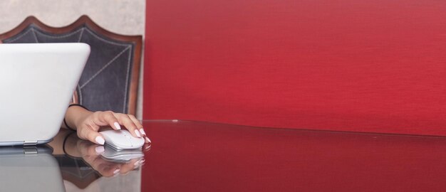 Woman using white laptop computer at home