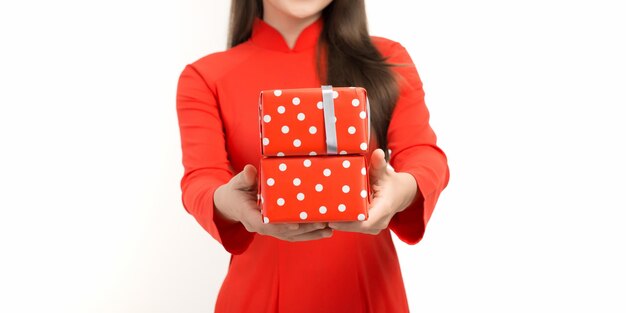 Woman in vietnamese traditional clothes giving gift box