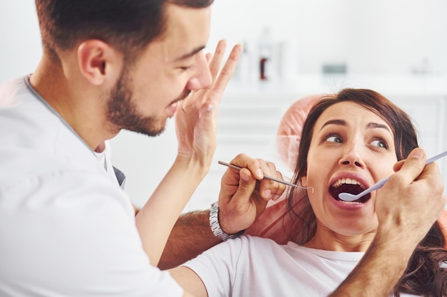 Woman visiting dentist in clinic Conception of stomatology