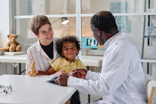 Woman visiting pediatrician with her little son