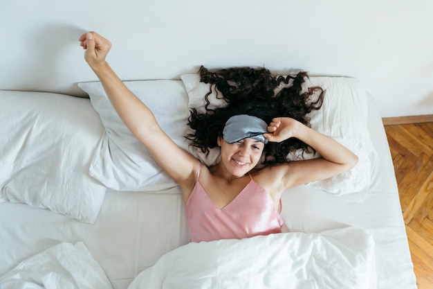 Woman waking at the bright morning sleeping mask