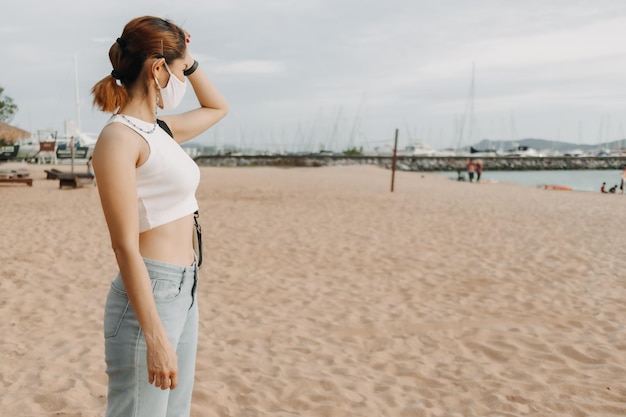 Woman walk on the beach in summer concept of summer holiday