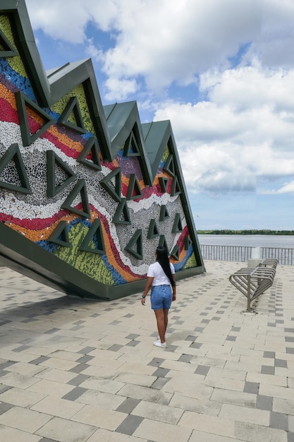 Woman walking along the promenade and the Magdalena river Barranquilla Colombia