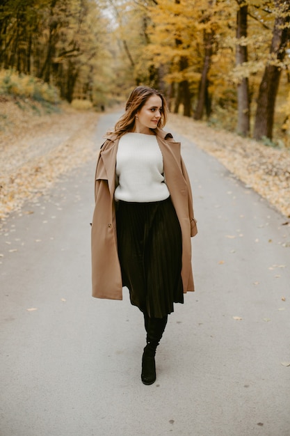 Woman walking in the autumn park