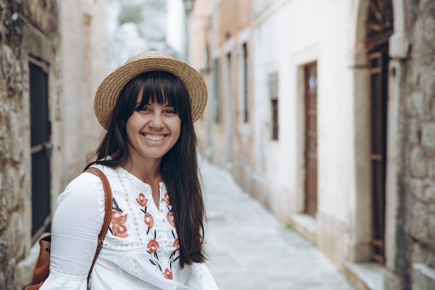 Woman walking by tight streets of kotor, montenegro