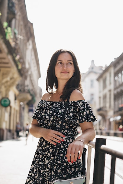 Woman walking on crowded city street from work