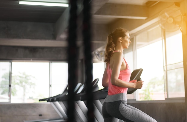 Woman walking and running cardio training at a gym Healthy workout concept