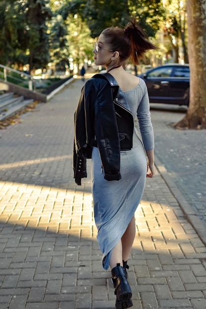 woman walking trough the street of city