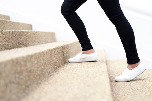 Woman walking up the stairs in an office building