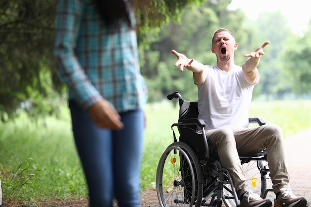 Woman walks away frustrated from man in wheelchair