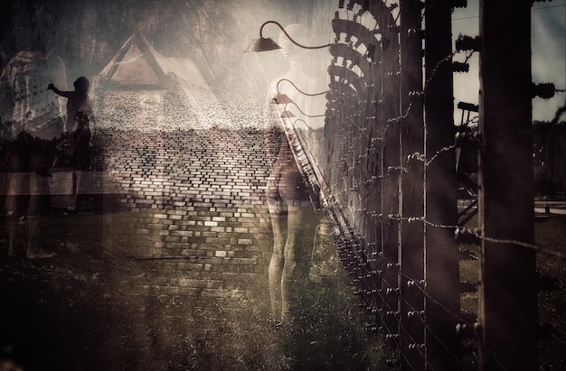 a woman walks past a brick wall with a light on it