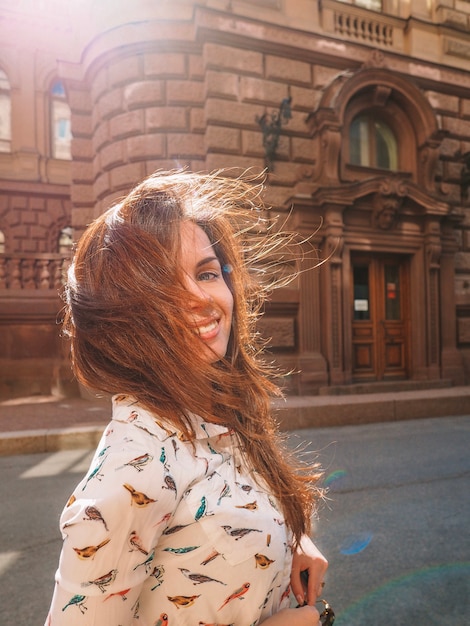 A woman walks through the streets, with historical building of Petersburg