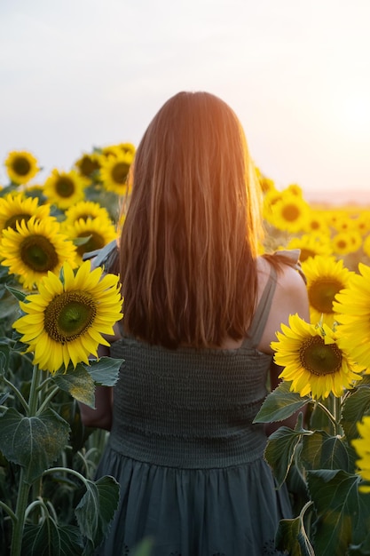 Woman walks through sunflowers enjoying vivid moments