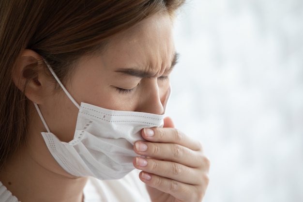 Woman waring protection mask from coronavirus and air pollution coughing so sickness,Health care concept