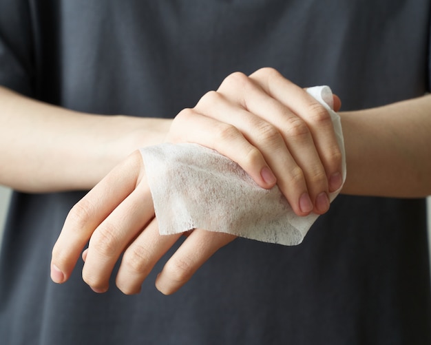 Woman wash hand wet wipes, to prevent illness Novel coronavirus (2019-nCoV) after public place