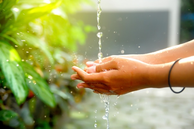 Woman washes her hands with water