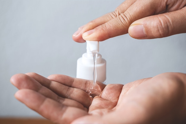 Woman washing hands with alcohol gel