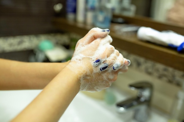 Woman washing her hands to avoid pandemic