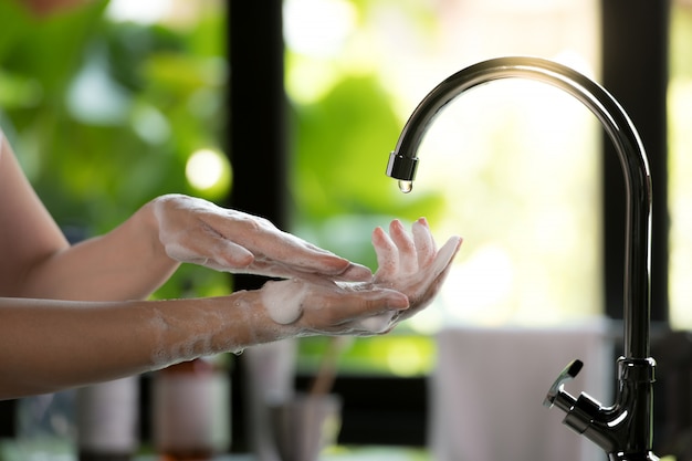 Woman washing her Hands with soap