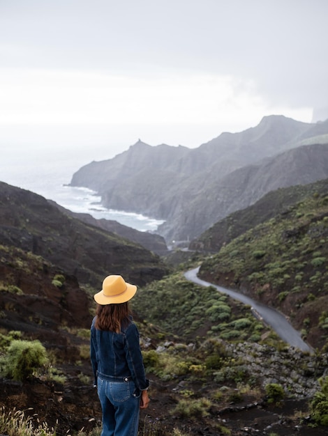 Woman watching the mountains landscape in La Gomera island