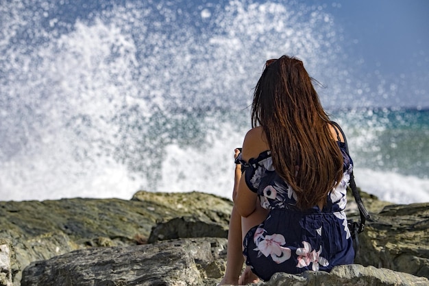 Woman watching Sea Storm tempest on the coast