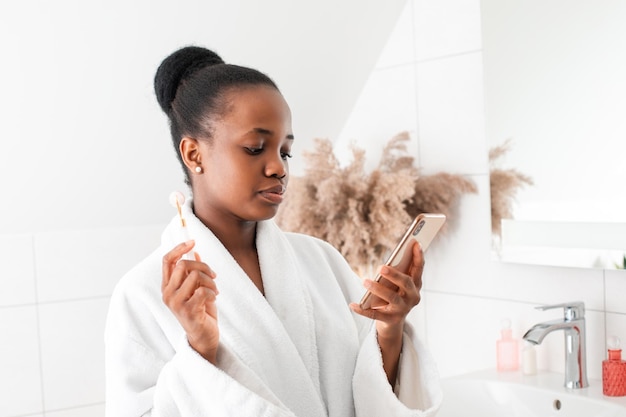 Woman watching tutorial how to use face massager