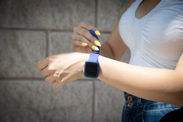 Woman wearing blue smart watch