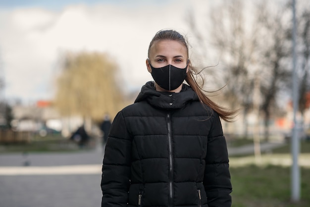 Woman wearing face mask because of Air pollution or virus epidemic in the city