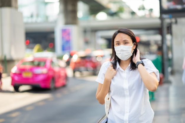 Woman wearing face mask protect filter against air pollution (PM2.5)