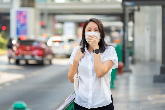 Woman wearing face mask protect filter against air pollution (PM2.5)