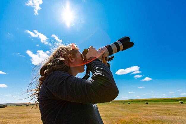 Woman wearing hat on field against sky