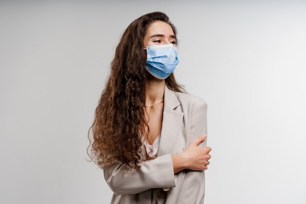 Woman wearing medical mask isolated on white background