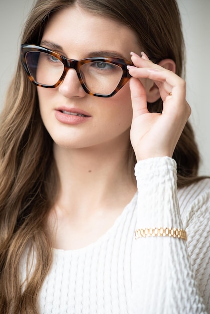 A woman wearing a pair of tortoiseshell glasses