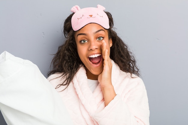 Woman wearing pajamas and a sleep mask