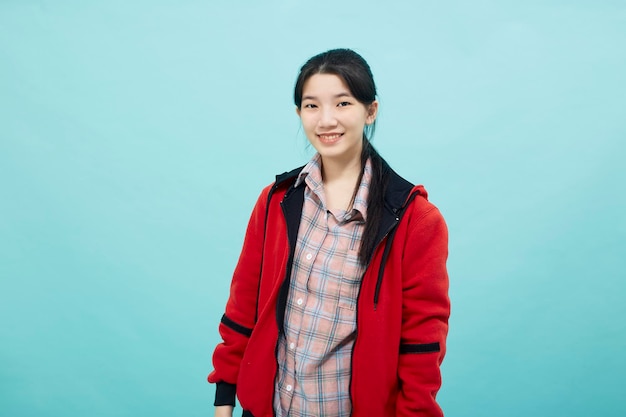 Woman wearing a red jacket smile looking confident at the camera studio lifestyle