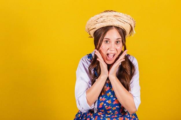 Woman wearing typical clothes for the Festa Junina Amazed overjoyed elated