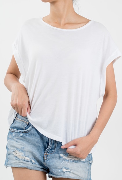 Woman wearing white t-shirt and short rip jeans on white