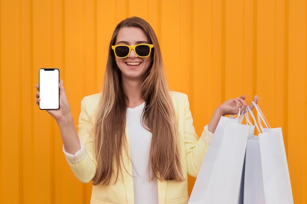 Woman wearing yellow clothes and holding a phone