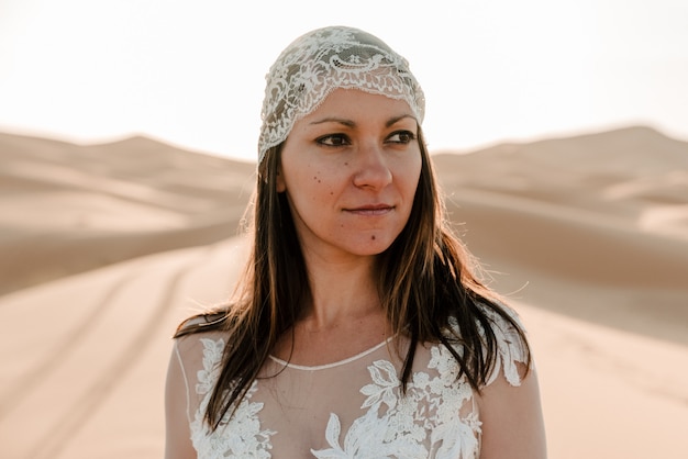 A woman in a wedding dress in the desert