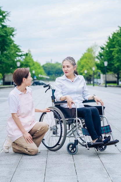 A woman in a wheelchair and a woman in an apron