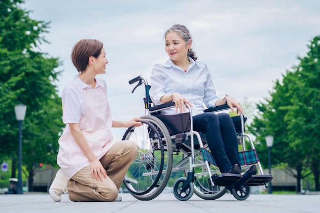 A woman in a wheelchair and a woman in an apron