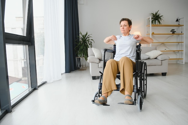 Woman in wheelchair working out in living room