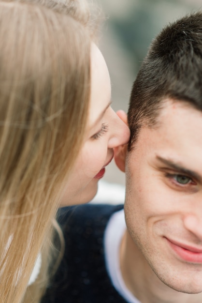 Woman whispering in a man ear