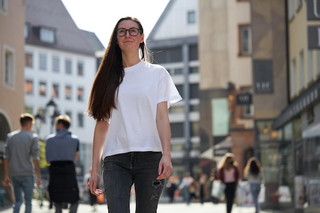 Woman in white blank tshirt wearing glasses in the city