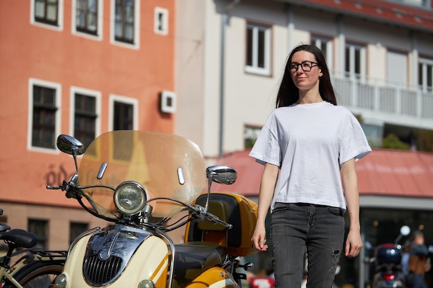 Woman in white blank tshirt wearing glasses in the city